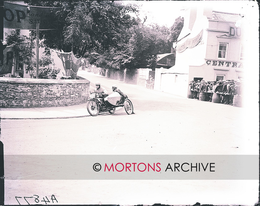 062 FROM THE PLATE 02 
 Freddie Dixon, with Walter Denny in the chair operation the banking faclilty. THe motorcycle is a Douglas. 
 Keywords: 1925 Sidecar TT, 2011, December, Mortons Archive, Mortons Media Group, Sidecars, Straight from the plate, The Classic MotorCycle