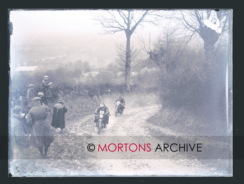 CARDIFF-LEICESTER 1928 01 
 E W Spencer (15, 348cc Douglas) and WR Latchem (14, 348cc Douglas) on the bend at the bottom of Bushcombe Hill. 
 Keywords: 1928 Cardiff - Leicester - Cardiff trial, 2011, Mortons Archive, Mortons Media Group, November, Straight from the plate, The Classic MotorCycle