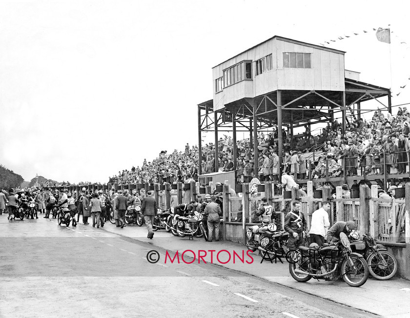 072-Closer-Look-01 
 The Summer of ' 46 - A welcome return, motorcycles lined up at the pits before the start of the combined Junior and Lightweight 1946 Manx GPGPs 
 Keywords: 2014, August, Closer look, Mortons Archive, Mortons Media Group Ltd, The Classic MotorCycle