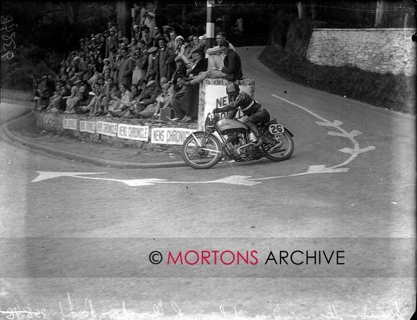 9384-11 
 1936 Junior and Lightweight Manx Grands Prix. Ron Hooper rounds Governors Bridge, on board his 246cc New Imperial. He finished fourth. 
 Keywords: 1936, 9384-11, glass plate, hooper, isle of mann, January 2010, manx, manx junior grand prix, Mortons Archive, Mortons Media, Mortons Media Group Ltd., new imperial, The Classic MotorCycle, tt