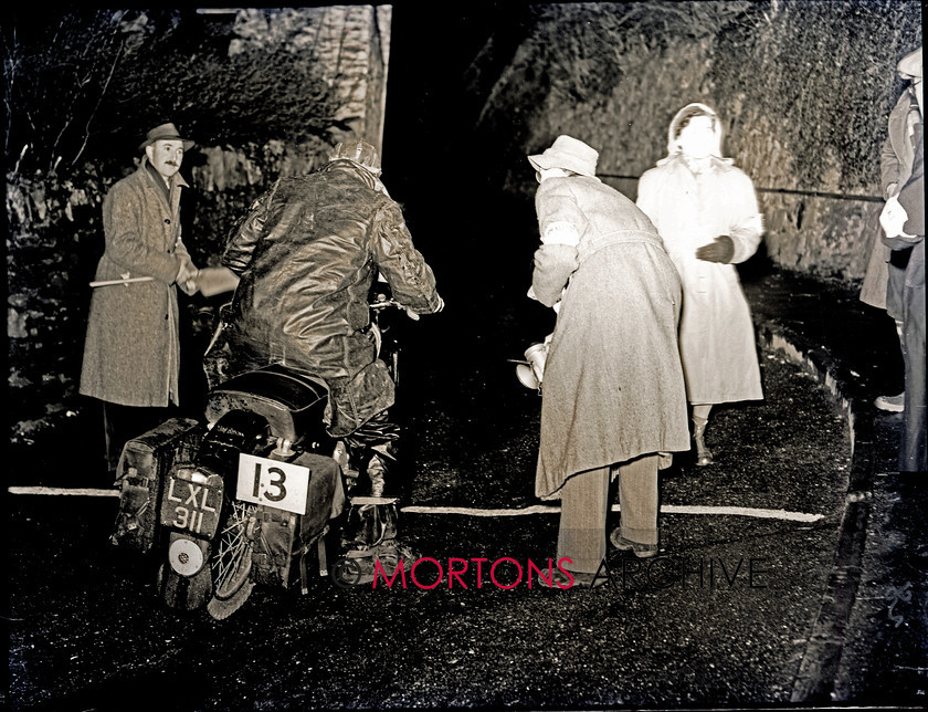 062 lands end 13 15151-34 
 1953 Lands End Trial - Aboard a swinging-arm framed Matchless, as well weather-protected rider on Station Lane. 
 Keywords: 2013, February, Glass plate, Mortons Archive, Mortons Media Group, Straight from the plate, The Classic MotorCycle, Trials