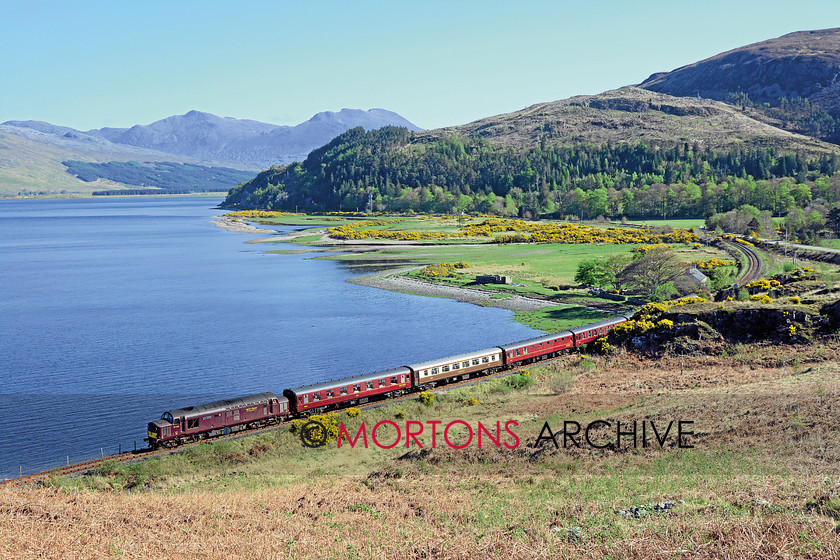 048 37516 Attadale 
 West Coast Railways' Class 37 No. 37516, substituting for the unavailable 'Black Five', skirts Loch Carron near Attadale on May 2. 
 Keywords: 2014, Heritage Railway, Issue 190, Mortons Archive, Mortons Media Group Ltd
