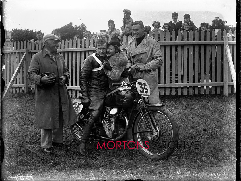 9384-03 
 1936 Junior and Lightweight Manx Grands Prix. Denis Parkinson (Excelsior) is congratulated post-race 
 Keywords: 1936, 9384-03, denis parkinson, excelsior, glass plate, isle of mann, January 2010, manx, manx junior grand prix, Mortons Archive, Mortons Media, Mortons Media Group Ltd., The Classic MotorCycle, tt