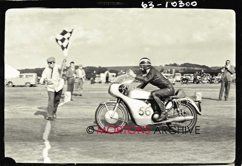 062 glass plate 07 
 The Norton 650cc SS strugles over the line with a failing clutch sustained near to the end of the race. Phil Read celebrates the victory. 
 Keywords: 1963, 2013, Glass plate, June, Mortons Archive, Mortons Media Group, Straight from the plate, The Classic MotorCycle, Thruxton 500 mile race