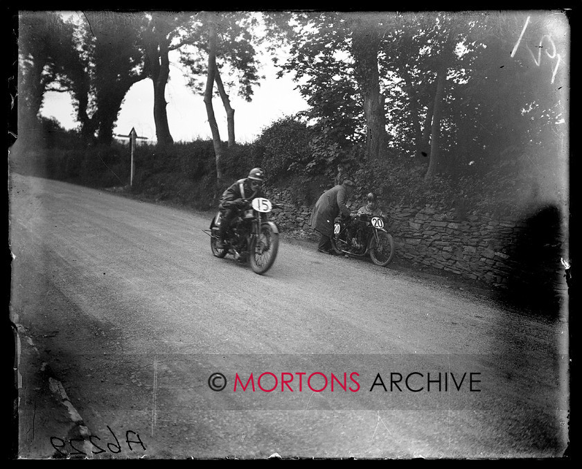 A6229 
 TT Junior/Lightweight 1926. Not even a sideways glance from Johnston, as he races past Gimpsey's stricken New Imperial. 
 Keywords: 1926, a6229, glass plate, isle of mann, junior, lightweight, Mortons Archive, Mortons Media Group Ltd, Straight from the plate, the classic motorcycle