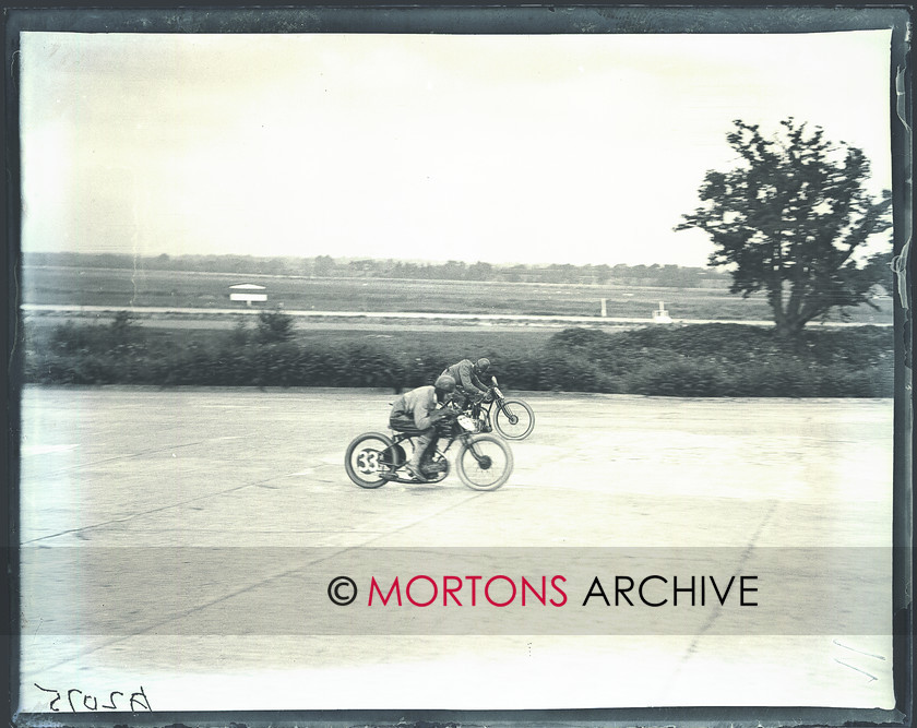 036 brooklands 02 
 Michael McEvoy (AJS) to the fore, George Tottey (New Imperial) behind. 
 Keywords: June 2011, Mortons Archive, Mortons Media Group, Straight from the plate, The Classic MotorCycle