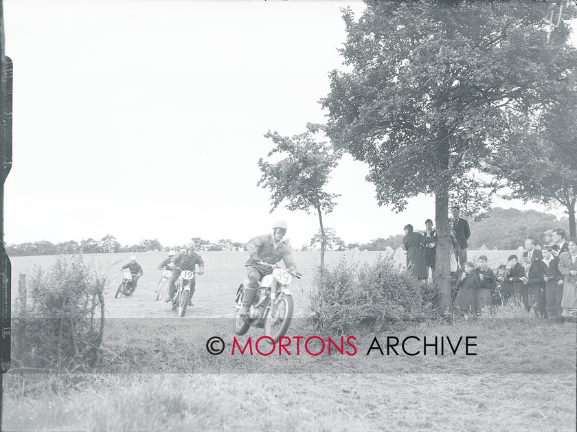 Straight FTP 04 
 NS Howells gets airbourne ahead of WA Bell. Terry Cheshire is number 25. 
 Keywords: 1954 Experts Grand Natinal Scramble, Action, Dec 10, Mortons Archive, Mortons Media Group, Straight from the plate, The Classic MotorCycle