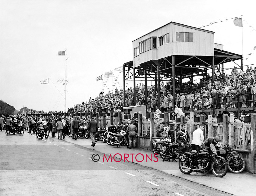 Manx 9E 
 9E – Nervous competitors make final adjustments ahead of the 1946 Junior MGP. 
 Keywords: 2012, Exhibition of historic images, Manx Grand Prix, Mortons Archive, Mortons Media Group, Mountain Milestones - Memories from Mona's Isle