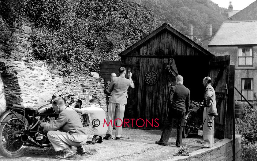 Manx 10B 
 10B – The AJS camp enjoy a game of darts watched by Jimmy Simpson, far right. 
 Keywords: 2012, Exhibition of historic images, Manx Grand Prix, Mortons Archive, Mortons Media Group, Mountain Milestones - Memories from Mona's Isle