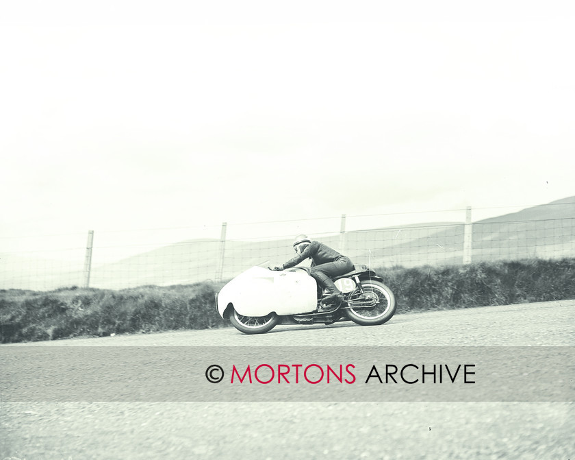 053 SFTP SENIOR TT 1957 03 
 A golden day at the Senior TT, 1957 - Eric Hinton (Norton) takes a lean just as some clouds start to roll in 
 Keywords: 1957, Glass plate, Isle of Man, Mortons Archive, Mortons Media Group Ltd, Straight from the plate, The Classic MotorCycle, TT