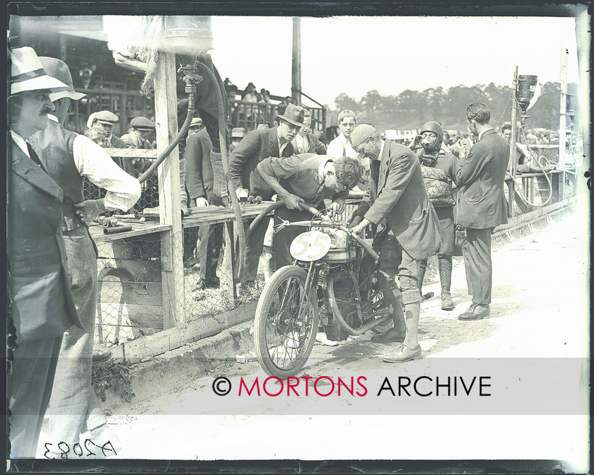 036 brooklands 06 
 With Denly out of the saddle taking on refreshment, the Norton is fuelled. 
 Keywords: June 2011, Mortons Archive, Mortons Media Group, Straight from the plate, The Classic MotorCycle