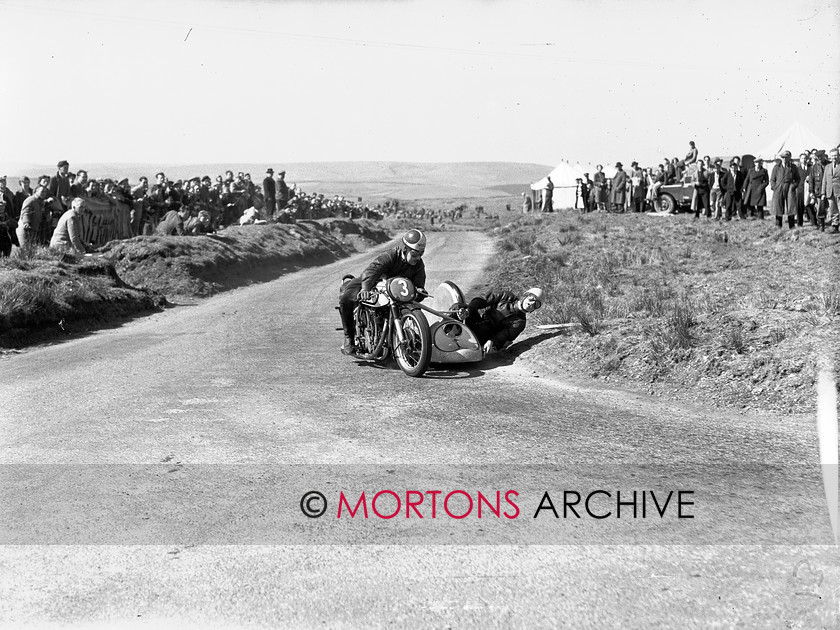15198-19 
 Eppynt Road Race 1953. The crew of LW Taylor's Norton outfit wears a startled expression as they corner in the 500cc sidecar race. 
 Keywords: 15198-19 sidecar, 1953, 3, April 2010, eppynt road race, glass plate, l w taylor, may, norton, racing, road, road race, Straight from the plate, tcm, The Classic Motorcycle, unit