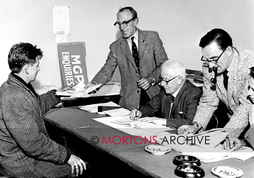 Manx 6E 
 7E – A competitor, his hands already showing signs of work, collects his numbers for the 1963 MGP. 
 Keywords: 2012, Exhibition of historic images, Manx Grand Prix, Mortons Archive, Mortons Media Group, Mountain Milestones - Memories from Mona's Isle
