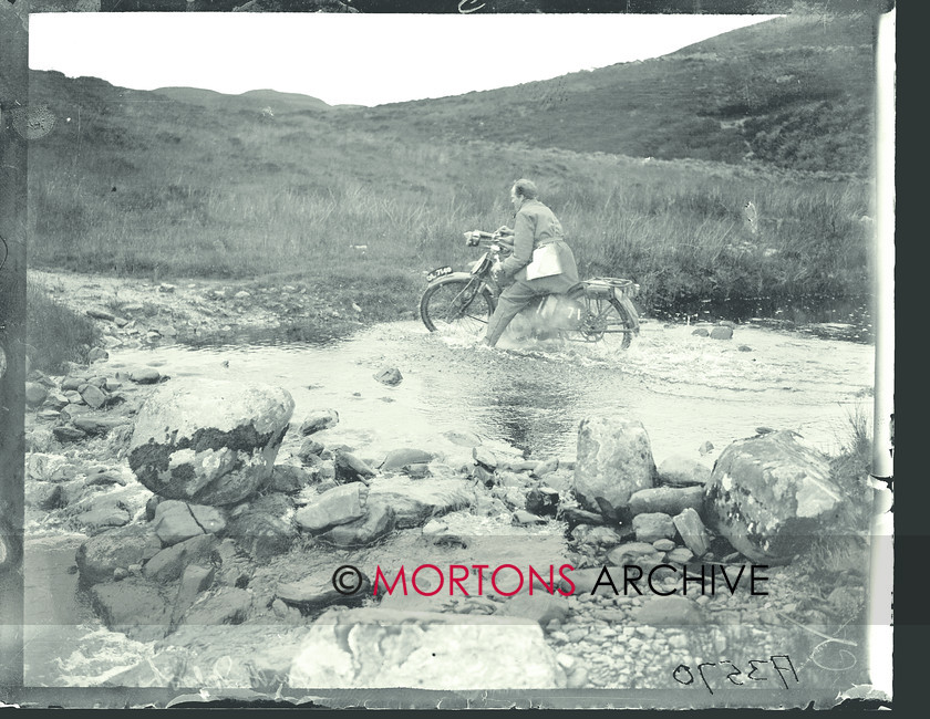 053 SFTP 04 
 The Scottish Six Days Trial, 1924 - trials and tribulations as one rider attempts to paddle his way across a shallow stream 
 Keywords: 1924, Glass plate, Mortons Archive, Mortons Media Group Ltd, Off road, Scottish Six Day Trial, Straight from the plate, The Classic MotorCycle