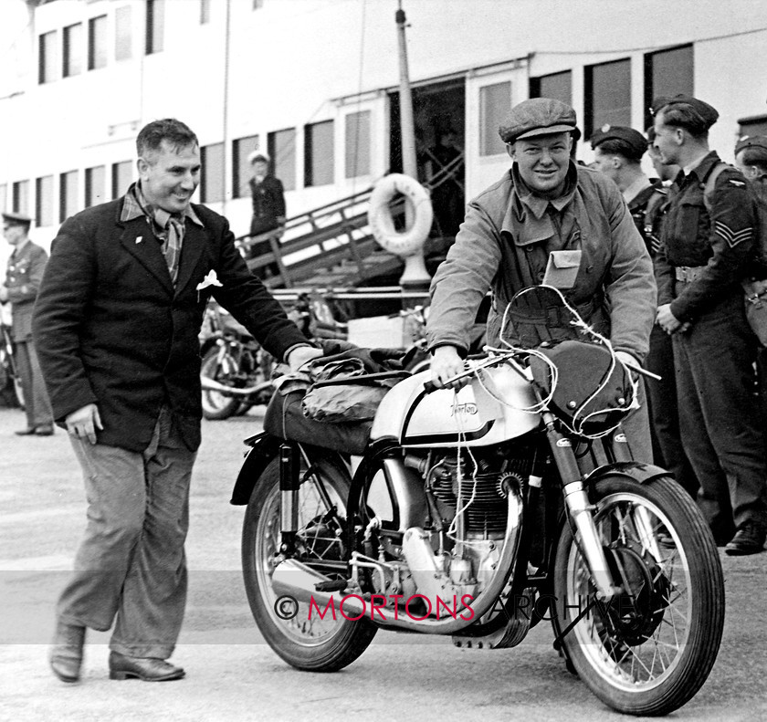 Manx 11A 
 12A - All the way from New Zealand for the 1951 TT genial Rod Coleman wheels his Norton ashore. 
 Keywords: 2012, Exhibition of historic images, Manx Grand Prix, Mortons Archive, Mortons Media Group, Mountain Milestones - Memories from Mona's Isle