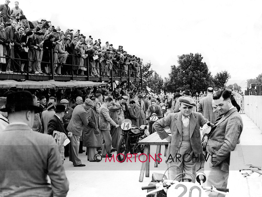 Manx 20B 
 20B – The weigh-in or scrutineering as we know it today, ahead of the 1951 TT causes a huge amount of interest. 
 Keywords: 2012, Exhibition of historic images, Manx Grand Prix, Mortons Archive, Mortons Media Group, Mountain Milestones - Memories from Mona's Isle