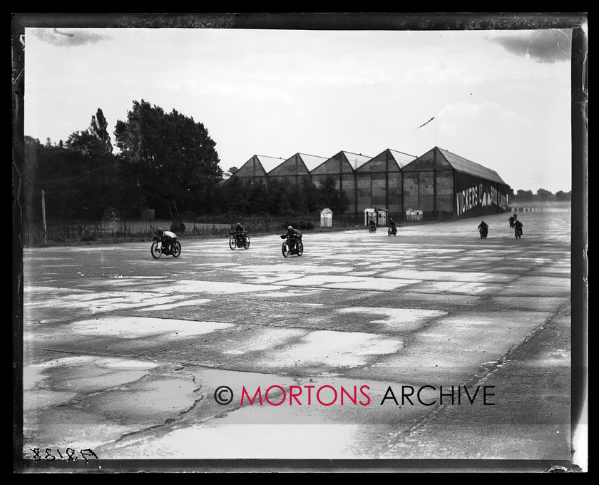 A2138 
 British Motor Cycle Racing Club's 5th monthly meeting, Brooklands 1923. Racing by the Vickers' building, with a lightweight - possibly Kaye Don on a 150cc Excelsior - to the fore. 
 Keywords: 1923, 5th meeting, A2138, bmcrc, brooklands, December 2009, glass plate, Straight from the plate, The Classic Motorcycle