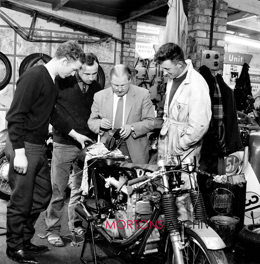 Manx 9C 
 9C – Sponsor Tom Kirby check the G50 brakes as, from left to right, John Jacques, Ron Chandler, and Roger Hunter look on as they prepare for the 1963 MGP. 
 Keywords: 2012, Exhibition of historic images, Manx Grand Prix, Mortons Archive, Mortons Media Group, Mountain Milestones - Memories from Mona's Isle