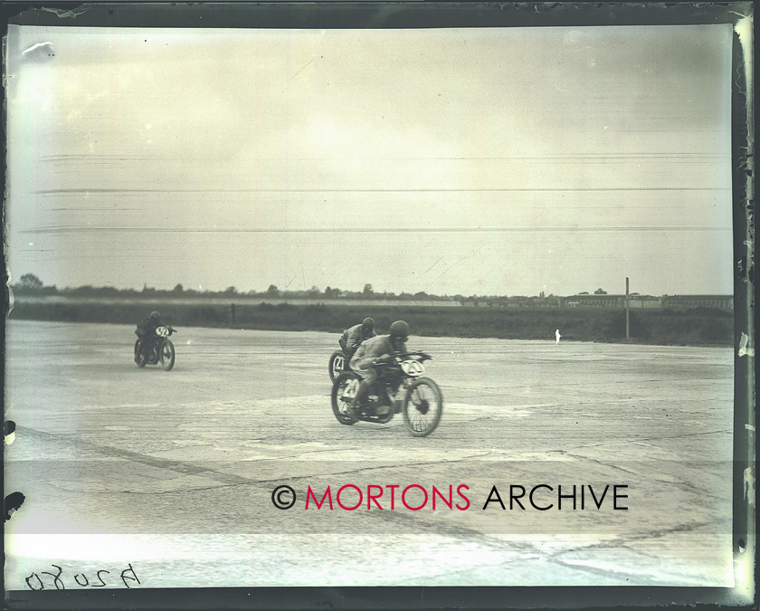 036 brooklands 04 
 Heads down and Charging - all riders faced several hours in the saddle. 
 Keywords: June 2011, Mortons Archive, Mortons Media Group, Straight from the plate, The Classic MotorCycle
