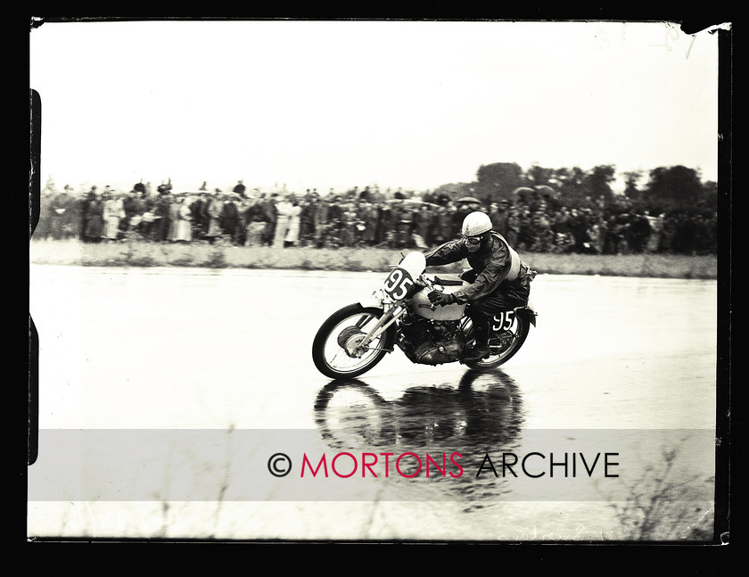 053 SFTP 1951 Thruxton A01 
 Wet day at Thruxton, August 1951 - Grey flash-mounted John Surtees, the man who Geoff Duke said "made me ride so fast in the last race". 
 Keywords: 2014, April, Glass Plates, Mortons Archive, Mortons Media Group Ltd, Straight from the plate, The Classic MotorCycle, Thruxton