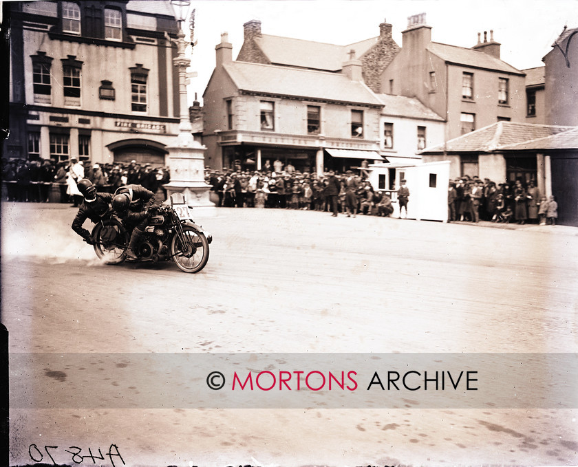 062 FROM THE PLATE 05 
 Owen Bridcutt, with S E Lewis in the sidecar, takes a peek at what the Dunelt's doing through Parliament Square. 
 Keywords: 1925 Sidecar TT, 2011, December, Mortons Archive, Mortons Media Group, Sidecars, Straight from the plate, The Classic MotorCycle