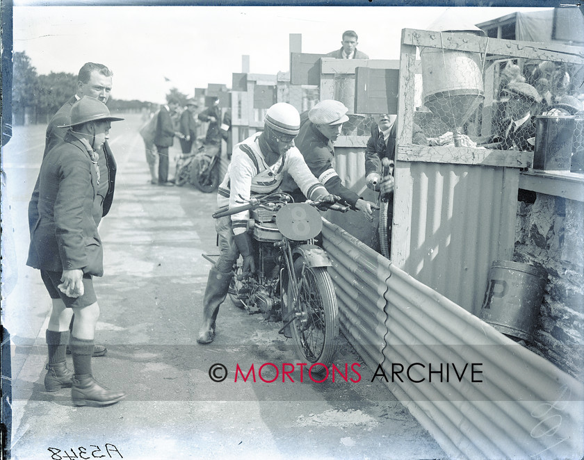 062 Plate 05 
 Dobbs stops at his pit; Archibald's Norton is abondoned in the background. 
 Keywords: 1925, Amateur TT, Glass plate, Mortons Archive, Mortons Media Group, Straight from the plate