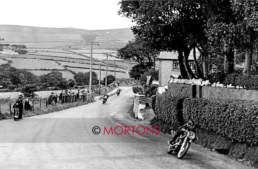 Manx 6D 
 7D – Local lad Derek Ennett leads into Cronk ny Mona during the 1952 Senior MGP. 
 Keywords: 2012, Exhibition of historic images, Manx Grand Prix, Mortons Archive, Mortons Media Group, Mountain Milestones - Memories from Mona's Isle