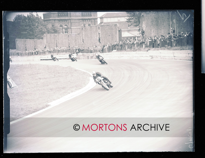 053 SFTP 4 
 Crystal Palace , August 1957 - JOhn Surtees again, here sweeping through on his Manx Norton, Alistair King leads the persuing pack. 
 Keywords: 2014, Crystal Palace, Glass plates, Mortons Archive, Mortons Media Group Ltd, November, Straight from the plate, The Classic MotorCycle